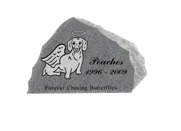 A rough grey granite pet marker with an etched dog and angel wings