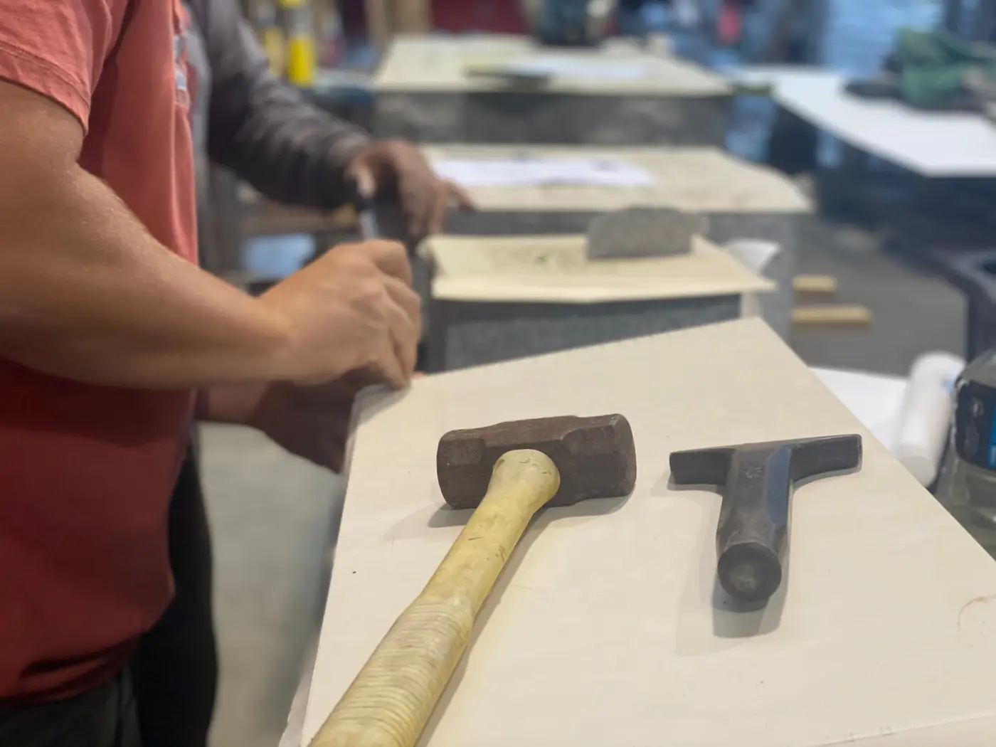 A mallet and chisel on a granite slab in the Hearn Monument shop