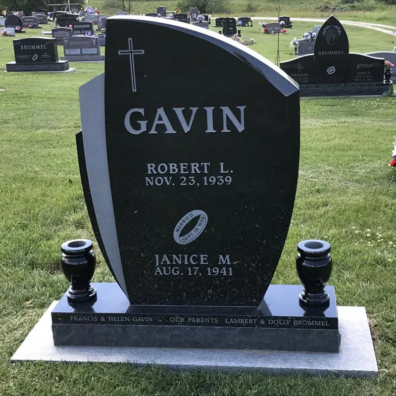 Black granite upright headstone with a curved top and two granite vases